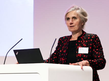 A woman standing at a lectern