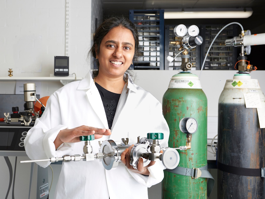 A woman in a laboratory, holding scientific equipment