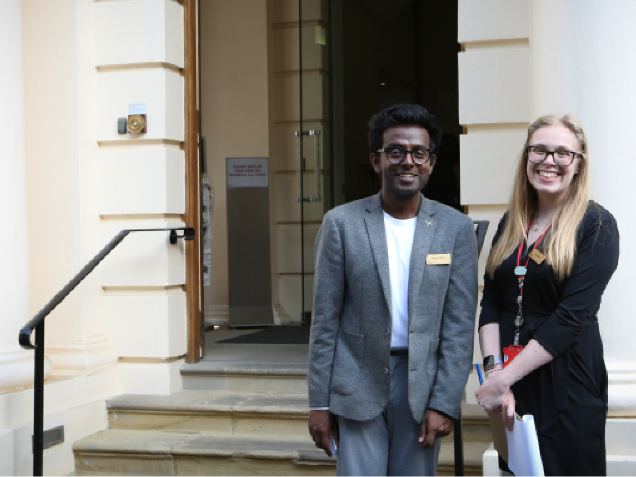 A man and a woman in front of a doorway