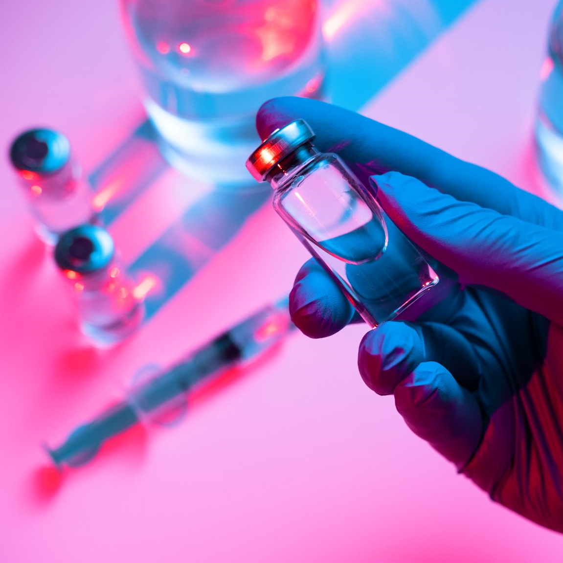 Gloved hand holding a vaccine