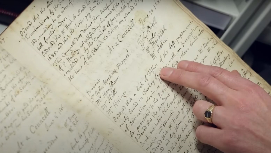 A hand on a book page