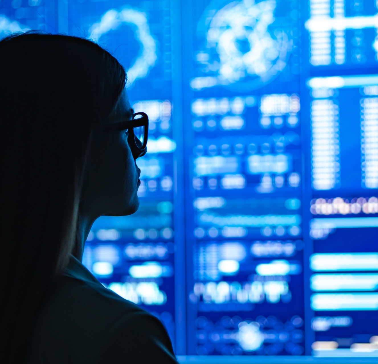 woman looking at large data screen