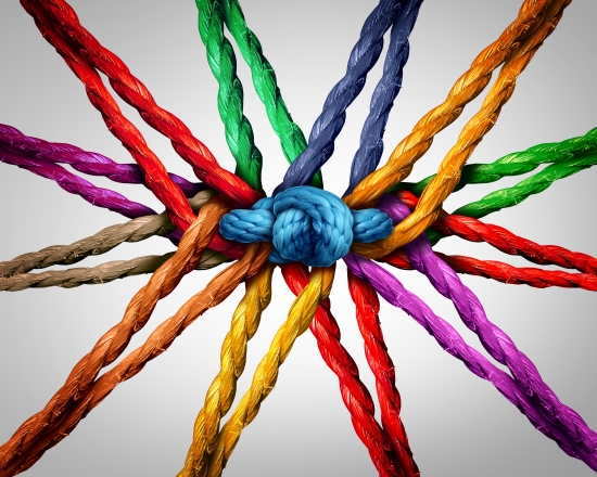 Group holding together as different ropes connected and tied and linked together in the center by a knot as a strong unbreakable chain and community trust and faith metaphor.